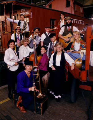 The Old World Folk Band posing in a historic train caboose